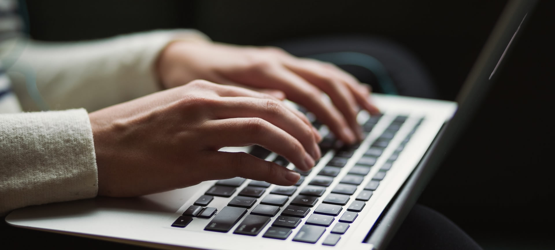 Typing on a laptop - creating web content